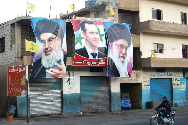  POSTERS DEPICTING Hezbollah leader Hassan Nasrallah, Syrian President Bashar Assad and Iran’s Supreme Leader Ayatollah Ali Khamenei in a village near the Lebanese-Syrian border. (photo credit: AZIZ TAHER/REUTERS)