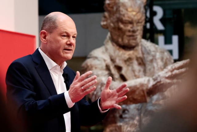  Germany's Social Democratic Party (SPD) candidate for chancellor Olaf Scholz attends a hybrid party conference for the approval of the traffic light coalition agreement at the party headquarters in Berlin, Germany, December 4, 2021 (photo credit: REUTERS)