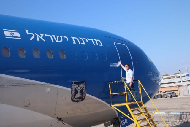  Israel Aerospace Industries workers’ union chairman Yair Katz is seen ceremonially removing the "experimental" sticker on the Wings of Zion, Israel's answer to Air Force One. (photo credit: Courtesy Yair Katz)