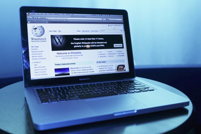  Wikipedia webpage in use on a laptop computer is seen in this photo illustration taken in Washington, January 17, 2012 (photo credit: REUTERS/GARY CAMERON)