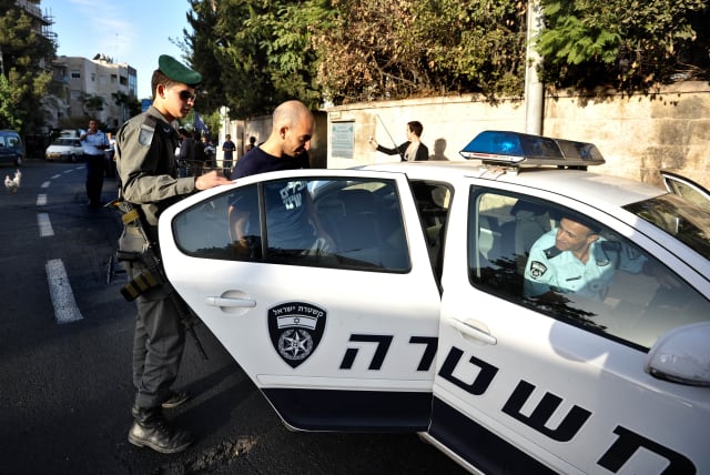  Israel Police officer in a police car (photo credit: FLASH90)