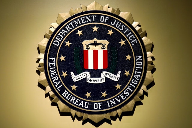  The Federal Bureau of Investigation seal is seen at FBI headquarters before a news conference by FBI Director Christopher Wray on the U.S Justice Department's inspector general's report regarding the actions of the Federal Bureau of Investigation and the 2016 US presidential election in Washington, (photo credit: REUTERS/YURI GRIPAS)