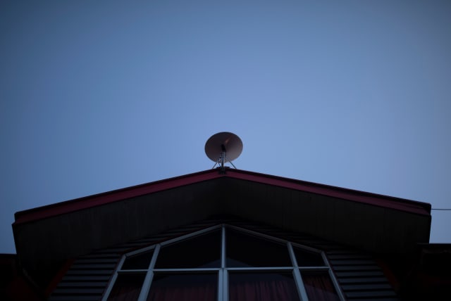  The Starlink antenna is seen on the roof of the John F Kennedy School located in the village of Sotomo, outside the town of Cochamo, Los Lagos region, Chile, August 7, 2021 (photo credit: Pablo Sanhueza/Reuters)