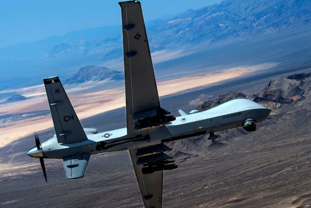 An MQ-9 Reaper remotely piloted drone aircraft performs aerial maneuvers over Creech Air Force Base, Nevada, US, June 25, 2015. (photo credit: US AIR FORCE/SENIOR AIRMAN CORY D. PAYNE/HANDOUT VIA REUTERS)
