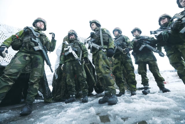  SWEDISH SOLDIERS take part in a military exercise called Cold Response 2022 in Evenes, Norway this week, gathering some 30,000 troops from NATO countries, plus Finland and Sweden, amid Russia’s invasion of Ukraine.  (photo credit: YVES HERMAN/REUTERS)