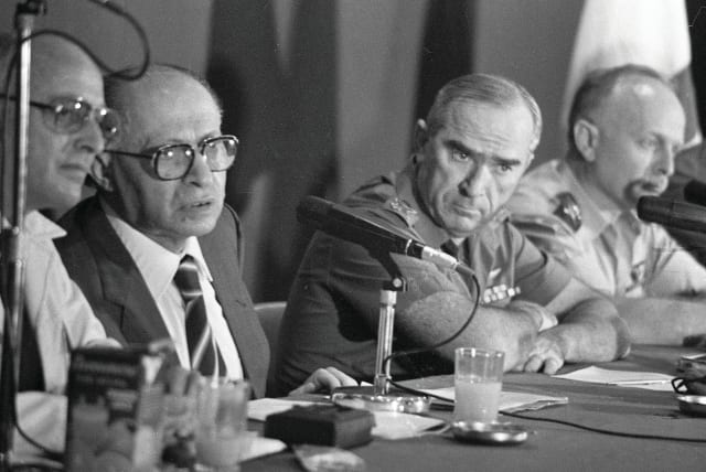  PRIME MINISTER Menachem Begin holds a special press conference to announce the Osirak reactor bombing, June 9, 1981. Also present: Uri Porat, PM media adviser (L) and IDF Chief of Staff Rafael ‘Raful’ Eitan (R).  (photo credit: NATIONAL LIBRARY OF ISRAEL)