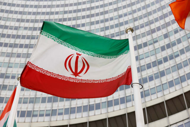  The Iranian flag waves in front of the International Atomic Energy Agency (IAEA) headquarters, amid the coronavirus disease (COVID-19) pandemic, in Vienna, Austria May 23, 2021. (photo credit: REUTERS/LEONHARD FOEGER)