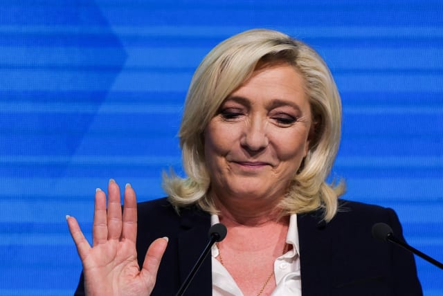 Marine Le Pen, leader of French far-right National Rally (Rassemblement National) party and candidate for the 2022 French presidential election, gestures as she delivers a speech after partial results in the first round of the 2022 French presidential election are announced, in Paris, France, April  (photo credit: REUTERS/PASCAL ROSSIGNOL)
