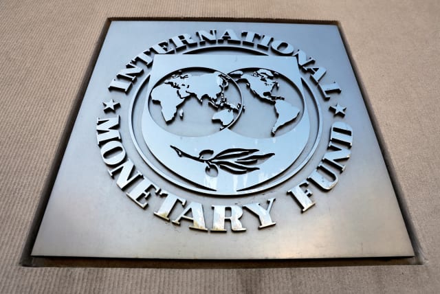 International Monetary Fund logo is seen outside the headquarters building during the IMF/World Bank spring meeting in Washington, US, April 20, 2018. (photo credit: REUTERS/YURI GRIPAS/FILE PHOTO)