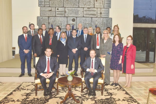 AMBASSADOR DANNY DANON, leading an international delegation of the UAE, Bahrain and Israel, sits next to President Isaac Herzog with the delegation at the President’s Residence in Jerusalem. (photo credit: Eyal Eliyahu)