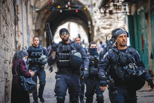  POLICE PATROL outside al-Aqsa Mosque amid clashes in the area this week. (photo credit: YONATAN SINDEL/FLASH90)