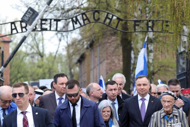  Polish President Andrzej Duda and Holocaust survivor Edward Mosberg attend the annual International "March of the Living" through the grounds of the former Auschwitz death camp, in Oswiecim, Poland April 28, 2022. (photo credit: REUTERS/KACPER PEMPEL)