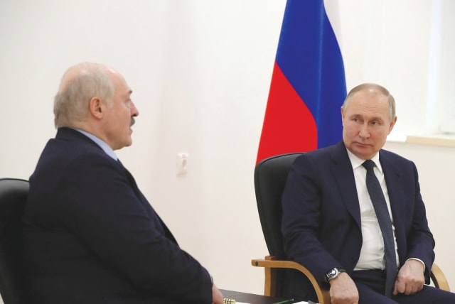 Russian President Vladimir Putin listens to Belarusian President Alexander Lukashenko during a meeting in Russia last month. Lukashenko has said Armenia can’t avoid Russia bringing it into an axis with Belarus.  (photo credit: Sputnik/Kremlin/Reuters)