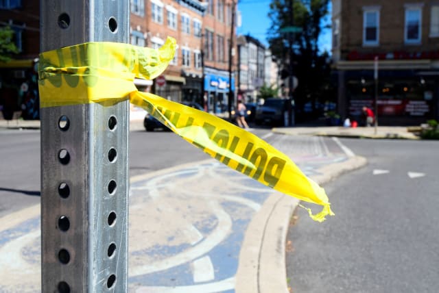  Police tape is pictured at a crime scene after a deadly mass shooting on South Street in Philadelphia, Pennsylvania, US, June 5, 2022. (photo credit: REUTERS/BASTIAAN SLABBERS)