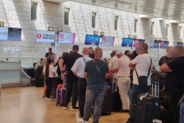  Israelis stand in line for a flight to Istanbul, at Ben-Gurion International Airport, outside of Tel Aviv, June 15, 2022. (photo credit: MAYA MARGIT/THE MEDIA LINE)
