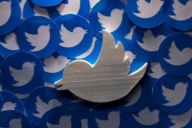  A 3D-printed Twitter logo on non-3D printed Twitter logos is seen in this picture illustration taken April 28, 2022 (photo credit: REUTERS/DADO RUVIC)
