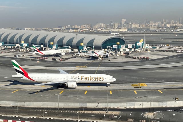 Emirates airliners are seen on the tarmac in a general view of Dubai International Airport in Dubai, United Arab Emirates, January 13, 2021. (photo credit: REUTERS/ABDEL HADI RAMAHI/FILE PHOTO)