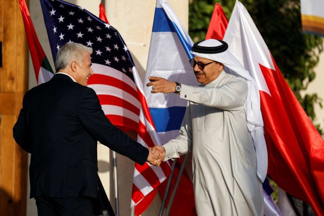 Bahrain Foreign Minister Dr. Abdullatif bin Rashid Al Zayani shakes hands with his Israeli counterpart Yair Lapid, the host of "The Negev Summit" which is attended by US Secretary of State Antony Blinken, and the foreign ministers of the UAE, Bahrain, Morocco and Egypt, in Sde Boker (photo credit: REUTERS/AMIR COHEN)