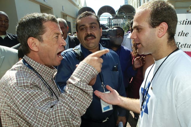  PALESTINIAN SUPPORTERS and Israeli delegates argue outside the World Conference Against Racism, in Durban, 2001.  (photo credit: REUTERS)
