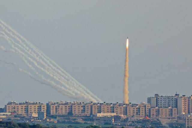  IRON DOME missile takes off near Ashkelon, as rockets are launched in the background from the Gaza Strip toward Israel (photo credit: JACK GUEZ/AFP VIA GETTY IMAGES)