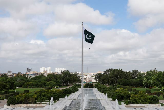 Pakistan's national flag flatters during a ceremony to celebrate Pakistan's 75th Independence Day, at the Mausoleum of Muhammad Ali Jinnah in Karachi, Pakistan, August 14, 2022. (photo credit: REUTERS/AKHTAR SOOMRO)