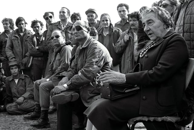  Prime minister Golda Meir, accompanied by her defense minister Moshe Dayan, meets with soldiers on the Golan Heights after the 1973 Yom Kippur War.  (photo credit: REUTERS)