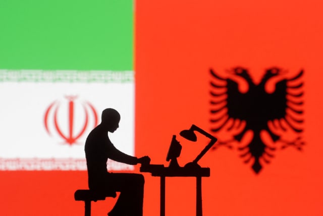 Figurines with computers are seen in front of Albanian and Iran flags in this illustration taken, September 10, 2022 (photo credit: REUTERS/DADO RUVIC/ILLUSTRATION)