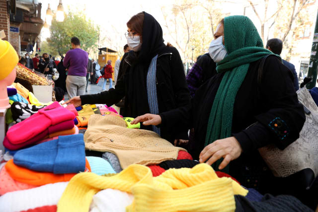 Women shop at a street in Tehran, Iran, November 29, 2021. (photo credit: MAJID ASGARIPOUR/WANA (WEST ASIA NEWS AGENCY) VIA REUTERS)