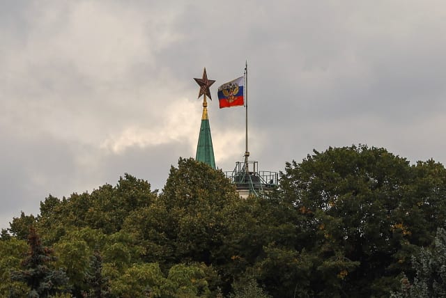  A Russian state flag flies near a tower of the Kremlin behind trees in central Moscow, Russia September 21, 2022. (photo credit: EVGENIA NOVOZHENINA/REUTERS)