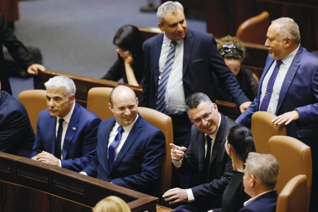  CABINET MINISTERS in the ‘government of change’ take their seats in the Knesset plenum upon their inauguration, June 2021. ‘This year – in light of the rickety political reality we are living in – I would add wishes for political stability,’ says the writer. (photo credit: OLIVIER FITOUSSI/FLASH90)