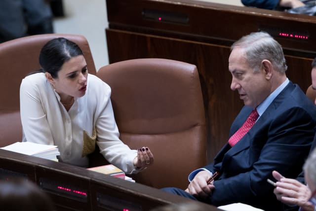  Prime Minister Benjamin Netanyahu speaks with then justice minister Ayelet Shaked (L) during a vote at the assembly hall of the Israeli parliament on December 21, 2016, during the state budget vote for 2017-2018.  (photo credit: YONATAN SINDEL/FLASH90)