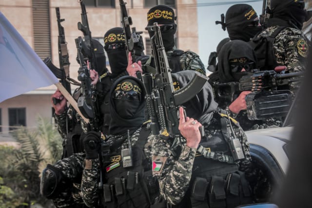  Palestinian militants from Al-Quds Brigades, the military wing of the Islamic Jihad movement, hold a military parade as part of the 35th anniversary of the foundation of the movement, in Gaza City on October 5, 2022.  (photo credit: ATTIA MUHAMMED/FLASH90)