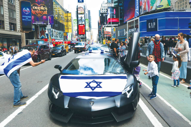  The Celebrate Israel Parade proceeds through Times Square in New York City, last year. When Israelis hear of Americans marching in the parade, they feel a sense of brotherhood, says the writer. (photo credit: CAITLIN OCHS/REUTERS)