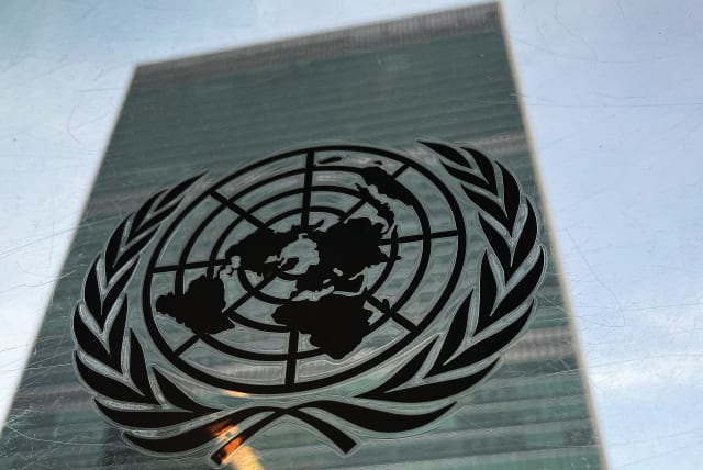  THE UNITED NATIONS headquarters building in New York City, and the UN logo: Today’s UN needs to be reimagined and reformed to address the limited problems it can effectively handle, says the writer. (photo credit: CARLO ALLEGRI/REUTERS)