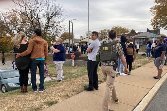  People gather following a shooting at a high school, in St. Louis, United States, October 24, 2022. (photo credit: Holly Edgell/NPR Midwest Newsroom/ via REUTERS)