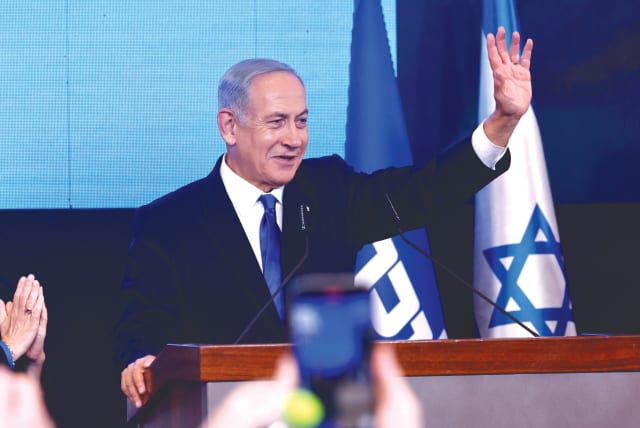  BENJAMIN NETANYAHU waves to well-wishers Tuesday night at his campaign victory celebration. (photo credit: MARC ISRAEL SELLEM/THE JERUSALEM POST)