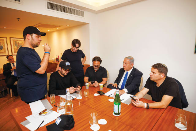  TEN MINUTES before the 10 p.m. exit poll announcements on election night, Benjamin Netanyahu and advisers, including the writer (standing center), consult and anticipate developments. (photo credit: ZIV KOREN)