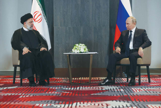  RUSSIAN PRESIDENT Vladimir Putin meets with Iranian President Ebrahim Raisi on the sidelines of the Shanghai Cooperation Organization summit in Uzbekistan, in September. (photo credit: SPUTNIK/REUTERS)