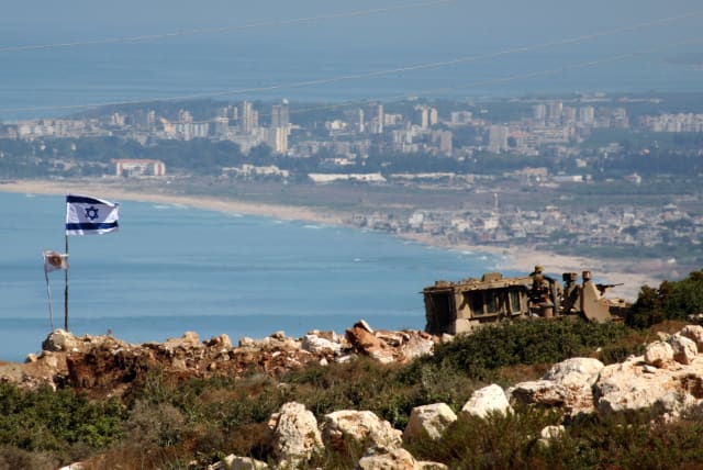  An Israeli flag flutters at an army position in the village of Baiyada, September 4, 2006, overlooking the southern Lebanese town of Tyre (photo credit: REINHARD KRAUSE/REUTERS)
