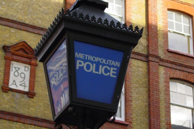 A photo of a traditional "blue lamp" as located outside most English police stations. This one is outside the Charing Cross Police Station of the Metropolitan Police in London. (photo credit: CANLEY/PUBLIC DOMAIN/VIA WIKIMEDIA COMMONS)