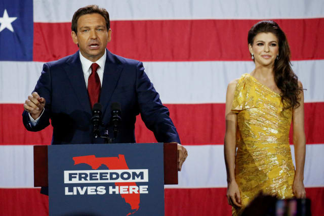  Republican Florida Governor Ron DeSantis speaks with his wife Casey DeSantis at his side during his 2022 US midterm elections night party in Tampa, Florida, US, November 8, 2022 (photo credit: REUTERS/MARCO BELLO)