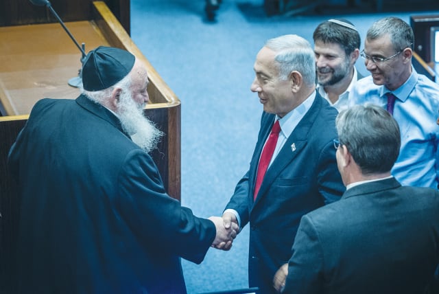  LIKUD LEADER BENJAMIN Netanyahu shakes hands with United Torah Judaism MK Yitzhak Goldknopf in the Knesset last week. If Netanyahu’s promise of a full budget for all haredi educational institutions is realized, the already-low incentive to provide core studies will disappear entirely. (photo credit: YONATAN SINDEL/FLASH90)