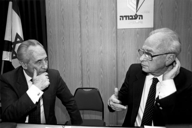  THEN-PRIME minister Yitzhak Rabin and his foreign minister Shimon Peres confer at a Labor Party meeting in 1993.  (photo credit: MOSHE SHAI/FLASH90)