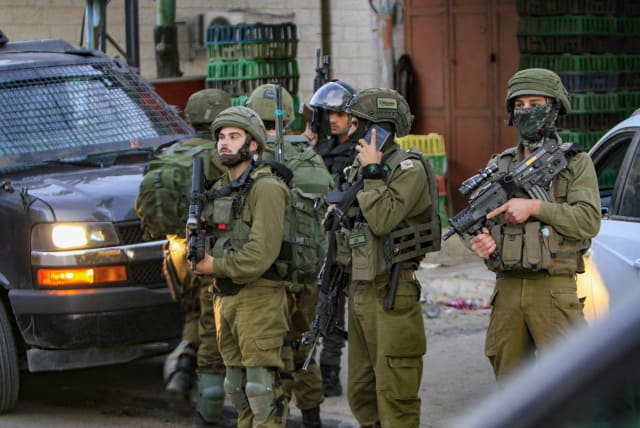 IDF soldiers secure the scene after a Border Police officer was stabbed in Huwara, December 2, 2022. (photo credit: NASSER ISHTAYEH/FLASH90)