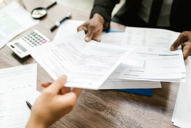  Person signing with insurance company (illustrative) (photo credit: PEXELS)