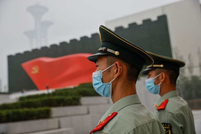  Officers of the People's Armed Police stand guard outside the Museum of the Communist Party of China that was opened ahead of the 100th founding anniversary of Party in Beijing, China June 25, 2021. (photo credit:  REUTERS/THOMAS PETER)