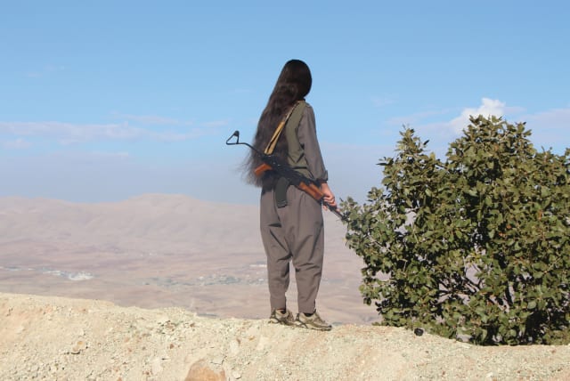  A KURDISH Komala fighter looks toward the Iranian border. (photo credit: JONATHAN SPYER)