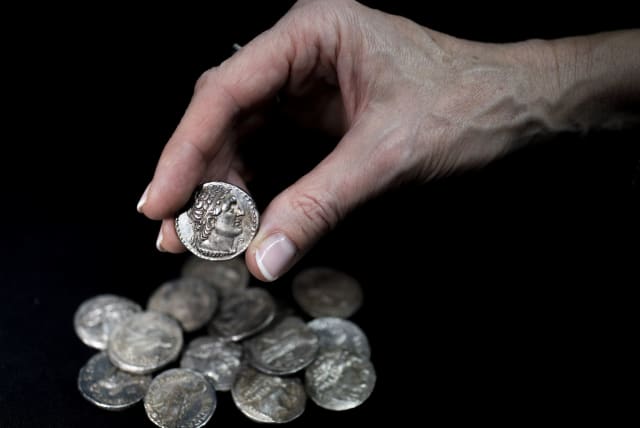  A wooden box containing 15 silver coins from the Maccabean period was discovered in the Judean Desert earlier this year, and will be put on display in the Hasmonean Museum in Modi'in, December 13, 2022. (photo credit: SHAI HALEVI / ISRAEL ANTIQUITIES AUTHORITY)