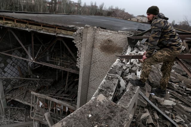  Pavlo, a Ukrainian soldier, stands on the roof of a damaged university, as Russia’s attack on Ukraine continues, from a recent missile attack in Kramatorsk Ukraine, December 13, 2022.  (photo credit: REUTERS/SHANNON STAPLETON)