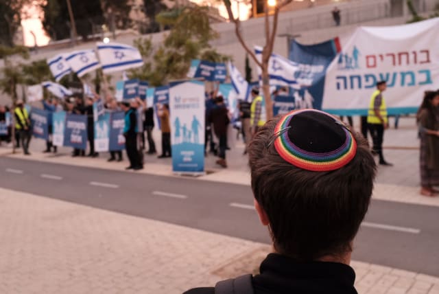  LGBT Rights activists wave flags and protest as religious Jewish activitsts protest against same-sex parenting and LGBT families, in Tel Aviv, on December 16, 2018.  (photo credit: TOMER NEUBERG/FLASH90)